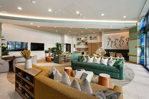 a living room with a green couch and a television